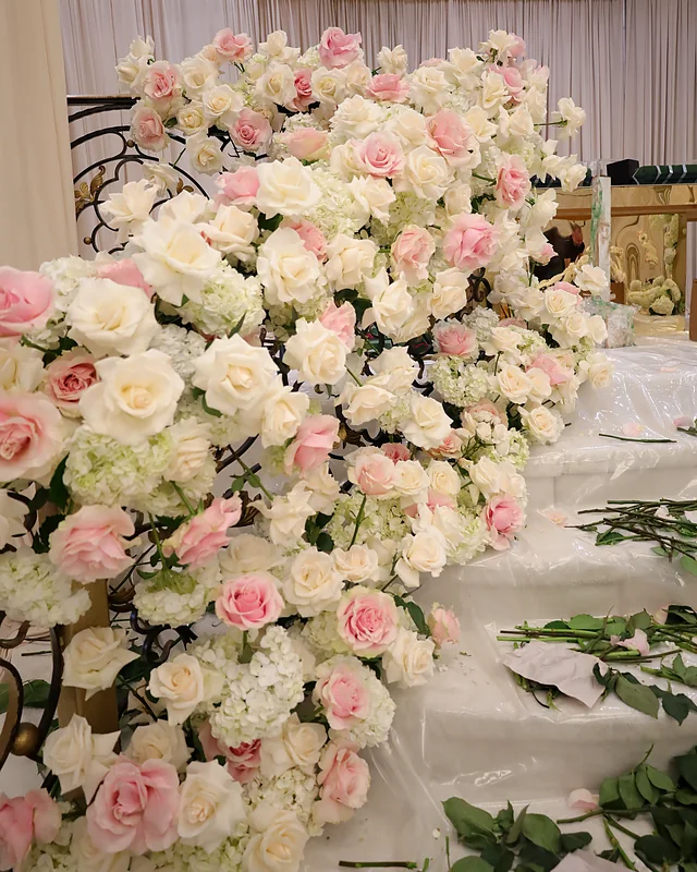 Blush and cream roses with hydrangea cascading down a tiered aisle installation