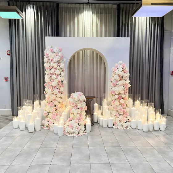 Floral columns, arch backdrop and candles for a celebration