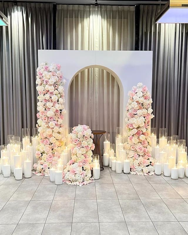Floral columns, arch backdrop and candles for a celebration