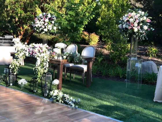 Outdoor garden wedding sweetheart table with tall floral arrangements